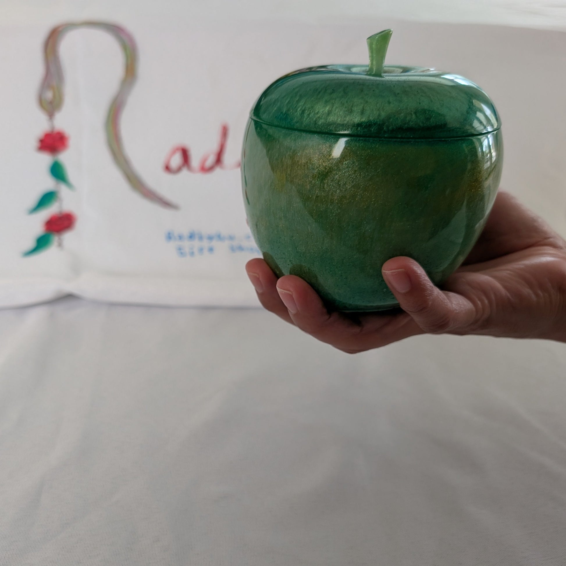 hand crafted with epoxy resin..

Epoxy resin is typically smooth, rigid, and non-porous, similar to a hard plastic or glass.

Knickknack - Resin apple trinket with lid