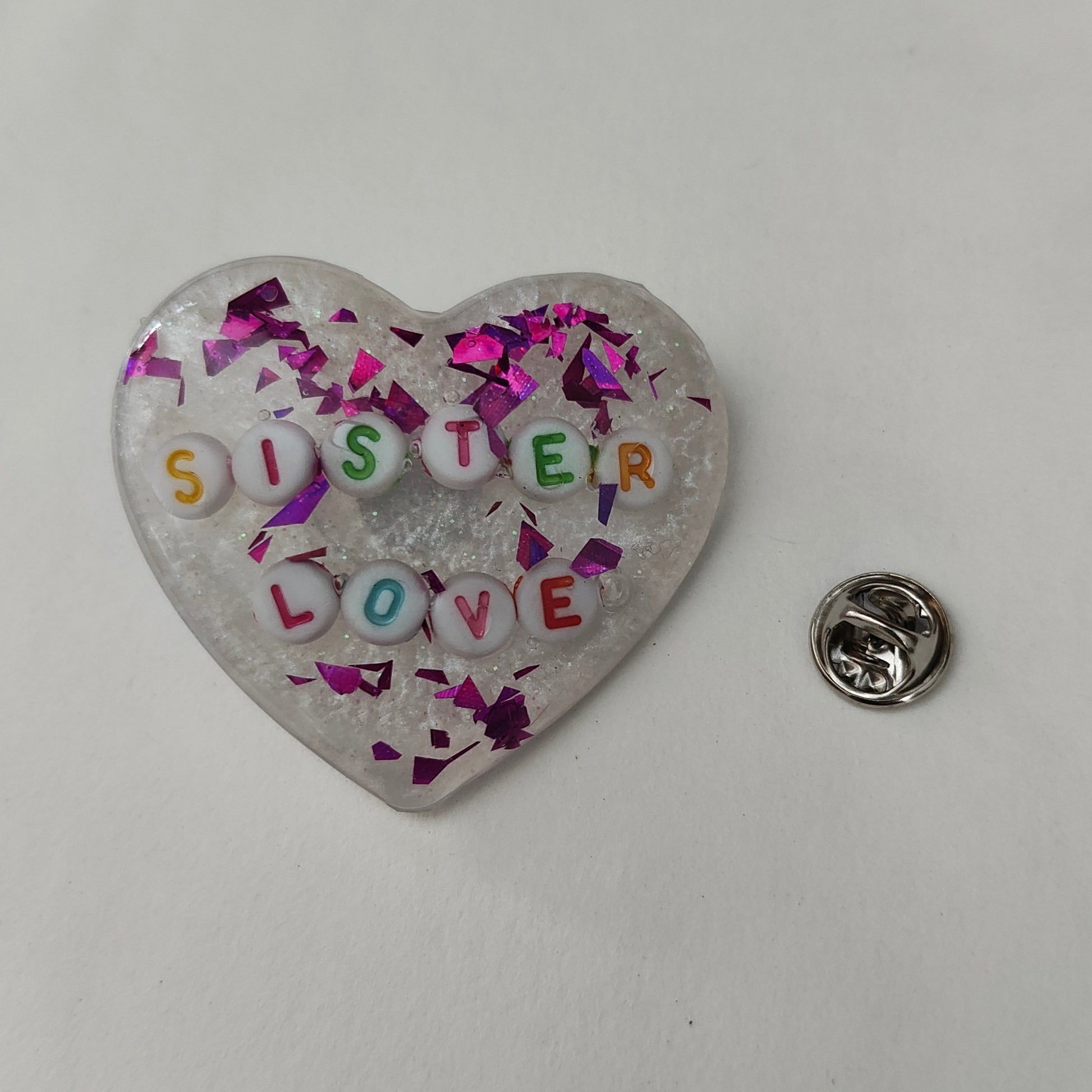 Wear your heart on your sleeve (or anywhere!) with this playful 3D resin heart pin. The silver butterfly clutch adds a touch of whimsy to this lightweight 0.40 oz accessory, measuring 1.75 x 2 in. Show your love with a pinch of quirkiness.