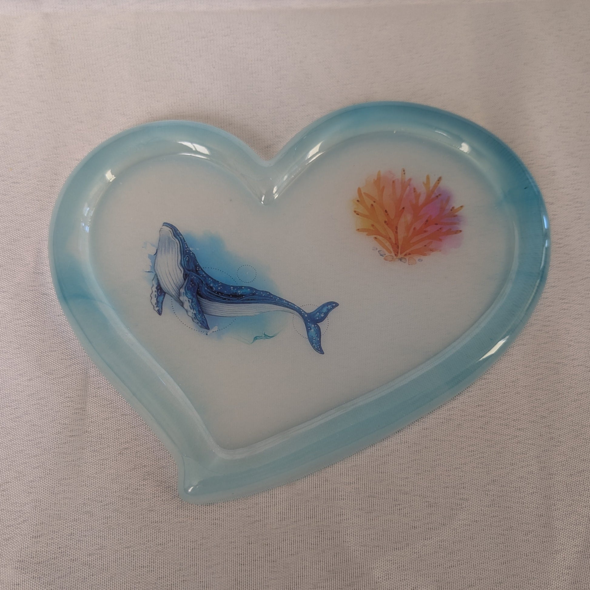 hand crafted with epoxy resin.

Epoxy resin is typically smooth, rigid, and non-porous, similar to a hard plastic or glass.