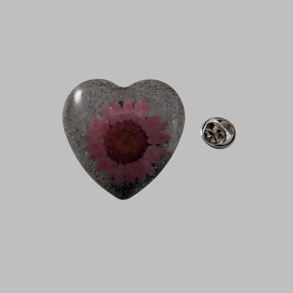 Add a touch of whimsy to any outfit with our 3D dried flower in resin pin. The stunning silver butterfly clutch ensures secure and easy attachment. Let this pin be your new go-to accessory for an elevated and playful look!