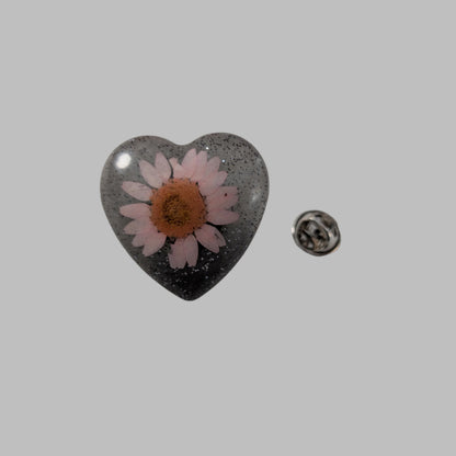 Add a touch of whimsy to any outfit with our 3D dried flower in resin pin. The stunning silver butterfly clutch ensures secure and easy attachment. Let this pin be your new go-to accessory for an elevated and playful look!