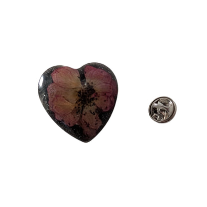 Add a touch of whimsy to any outfit with our 3D dried flower in resin pin. The stunning silver butterfly clutch ensures secure and easy attachment. Let this pin be your new go-to accessory for an elevated and playful look!