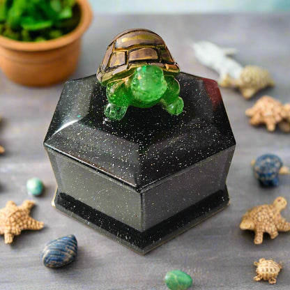 Add a playful touch to your home decor with this Knickknack! The resin hexagon trinket box features a turtle lid and is the perfect size for storing small treasures. With dimensions of 2.5 x 3 x 1 inches and weighing only 3.4 ounces, it's a quirky and lightweight addition to any room.