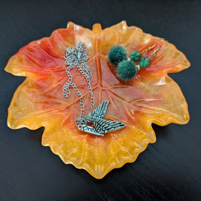 Elevate your space with the Knickknack Resin Maple Leaf Trinket Tray. Crafted with care, its vibrant maple leaf design adds a touch of nature-inspired charm while keeping your small essentials organized. Perfect for keys, jewelry, or coins, this tray combines functionality with seasonal style, making it a must-have accent for any room.