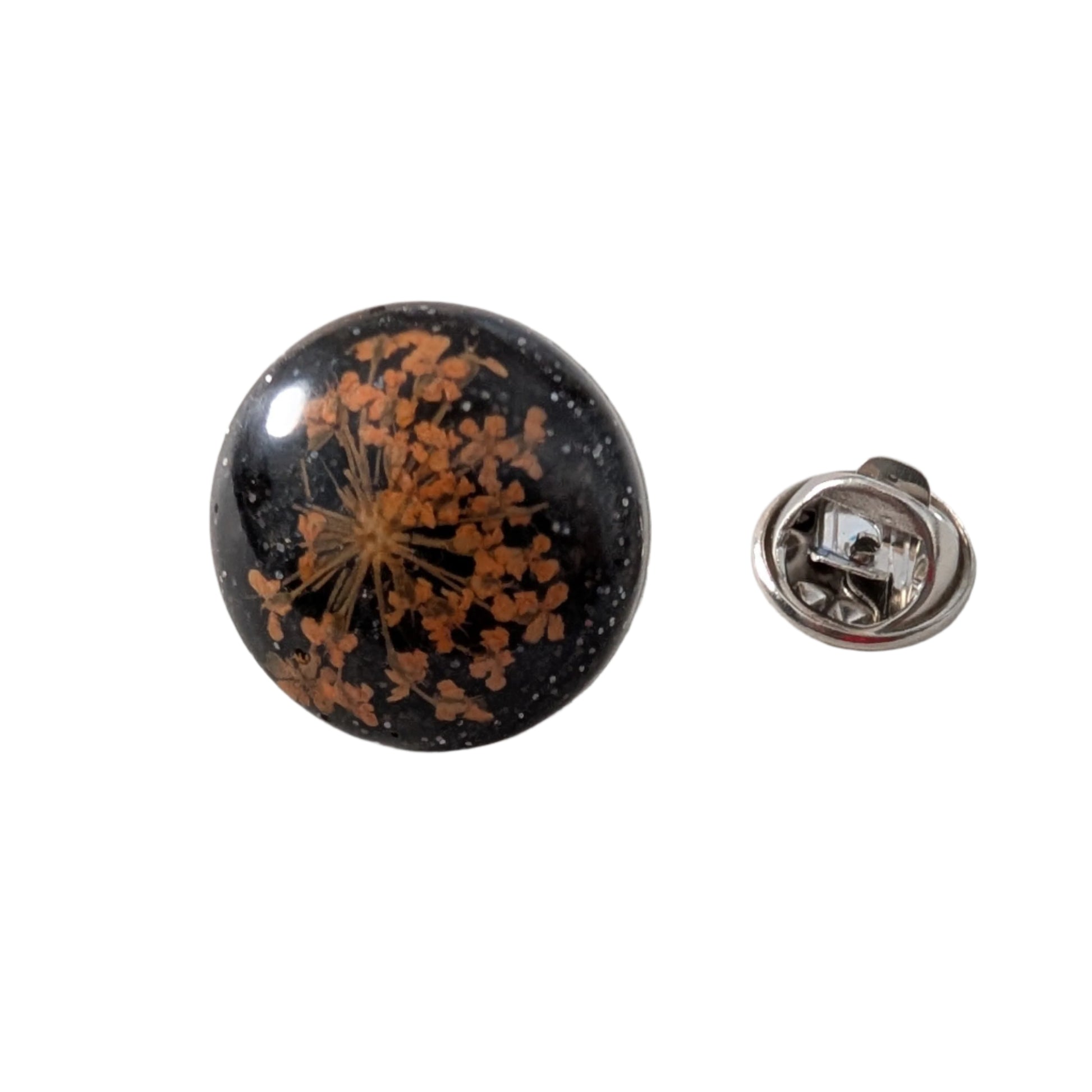 Add a touch of nature to your outfit with our Pin - 3D dried flower resin pin. The intricate design and 3D effect will surely catch everyone's eye. With the sturdy silver butterfly clutch, your pin will stay securely in place. Elevate your style with this unique and beautiful accessory.