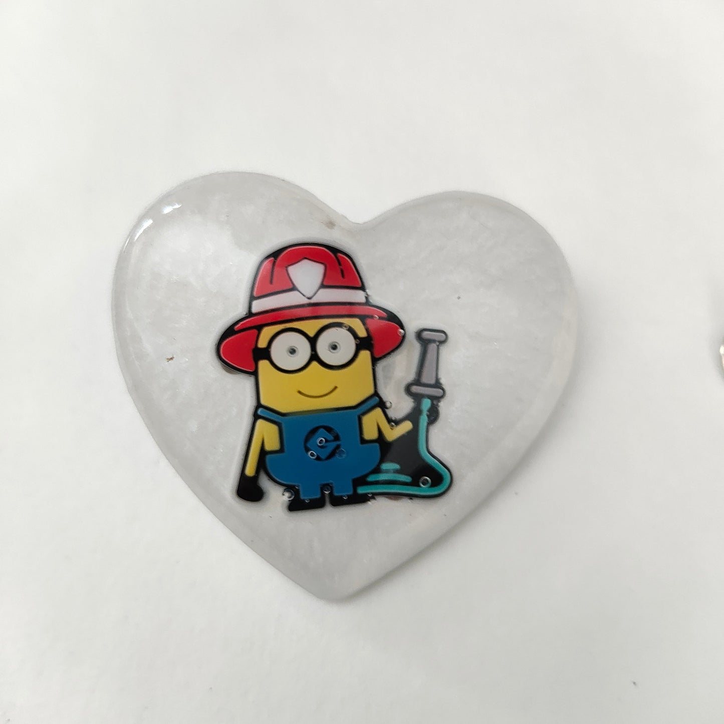 Get ready to add a touch of mischief to your outfit with our 3D minions resin pin! This playful pin features a silver butterfly clutch for easy application and measures 1.75 x 2 inches. Weighing only 0.40 oz, it's the perfect accessory for any outfit. Join the minion madness and grab yours today!

Pin - 3D minions resin pin with silver butterfly clutch