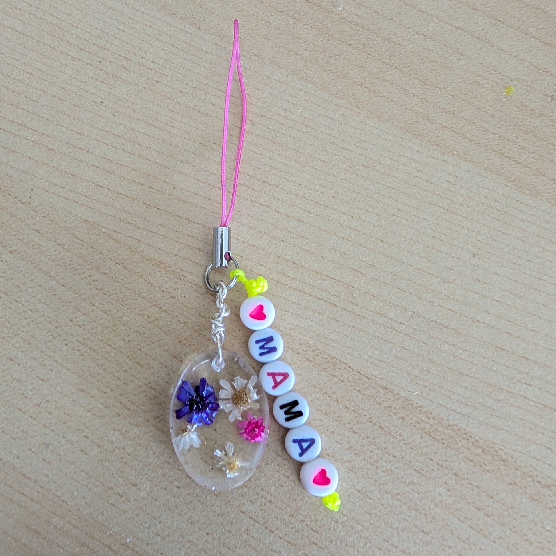 Spice up your phone with this charming resin charm, adorned with real dried flowers and beads. The 3.75 inch length adds a touch of flair to any device. (It's like a bouquet, but for your phone!)

Phone charm - Resin charm with dried flowers and beads