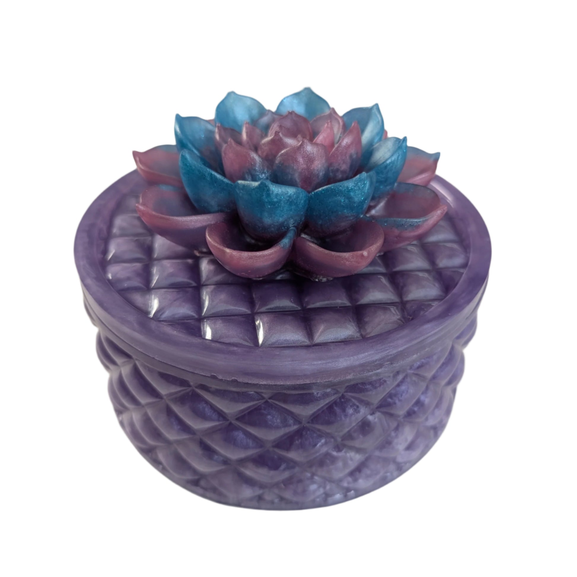 Keep your tiniest treasures safe in our round trinket box. With a charming resin design and a beautiful flower lid, it adds a playful touch to any space. At approximately 5 x 5 in, 4.25 in height, and weighing 11.7 oz, it's perfect for your precious items.