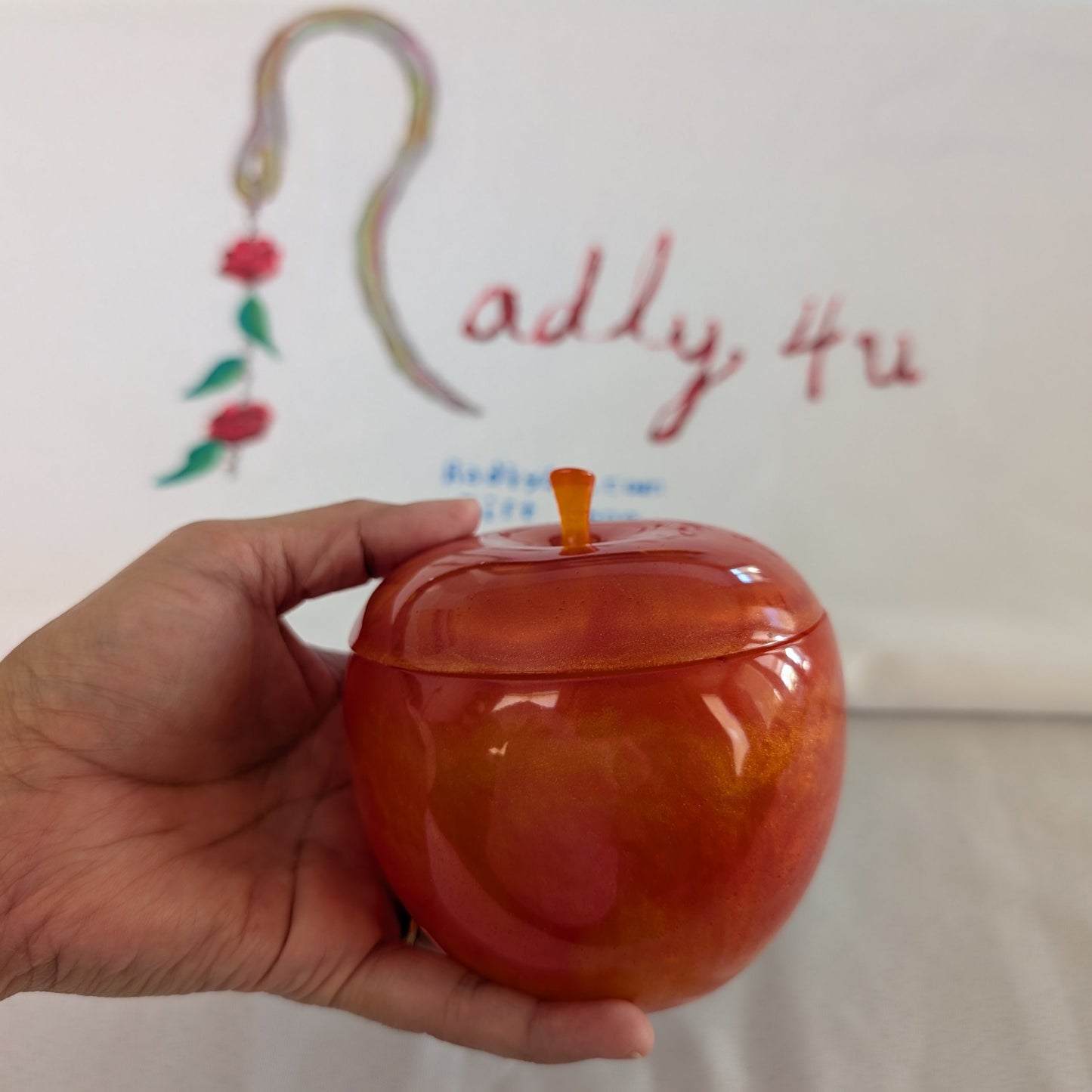 hand crafted with epoxy resin..

Epoxy resin is typically smooth, rigid, and non-porous, similar to a hard plastic or glass.

Knickknack - Resin apple trinket with lid