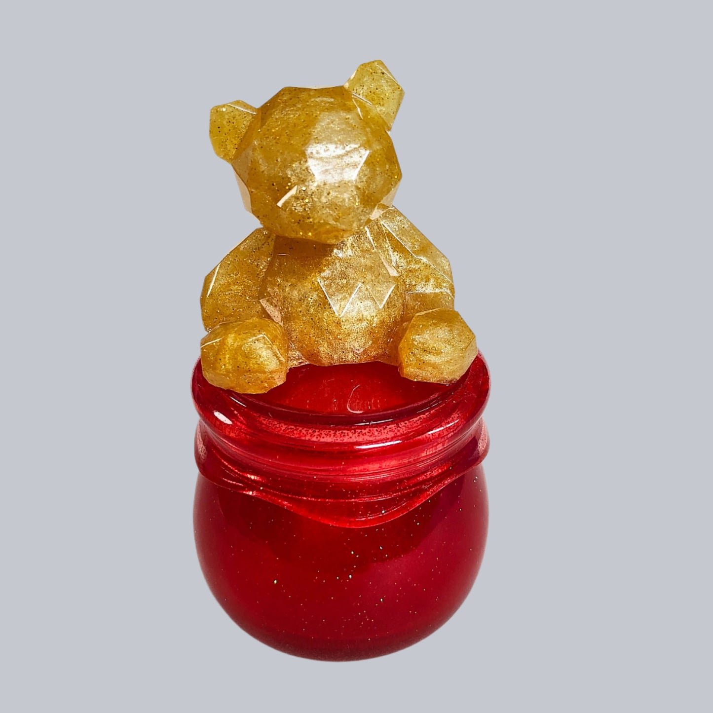 Add a touch of whimsy to your home with our Knickknack - Resin Jar. Featuring a playful bear screw on lid, this jar is perfect for storing small items. Measuring 2.75 x 2.75 inches with a height of 5 inches and a weight of 7.8 oz, it's both functional and fun!

Resin Jar with bear screw on lid