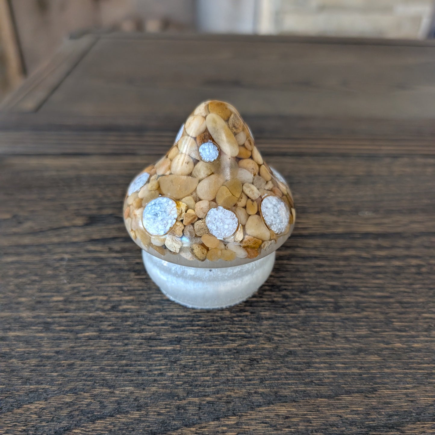 Decorative mushroom with stone cap on a wooden surface