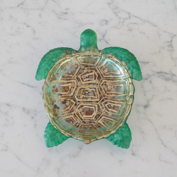 Decorative turtle-shaped dish with intricate design on a marble surface
