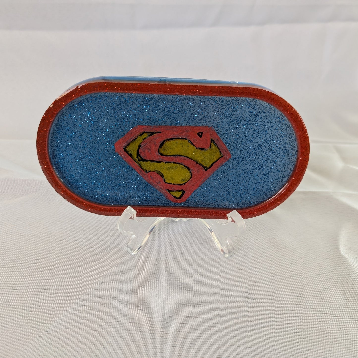 This Knickknack trinket dish not only adds a fun touch to any space with its super hero theme, but also serves as a functional and stylish storage option for small items. Made of durable resin, it is designed to keep jewelry, change, and other trinkets organized and easily accessible.