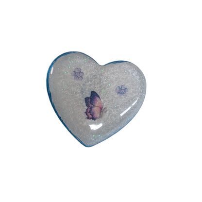 Wear your heart on your sleeve (or anywhere!) with this playful 3D resin heart pin. The silver butterfly clutch adds a touch of whimsy to this lightweight 0.40 oz accessory, measuring 1.75 x 2 in. Show your love with a pinch of quirkiness.

Pin - 3D resin heart pin with silver butterfly clutch