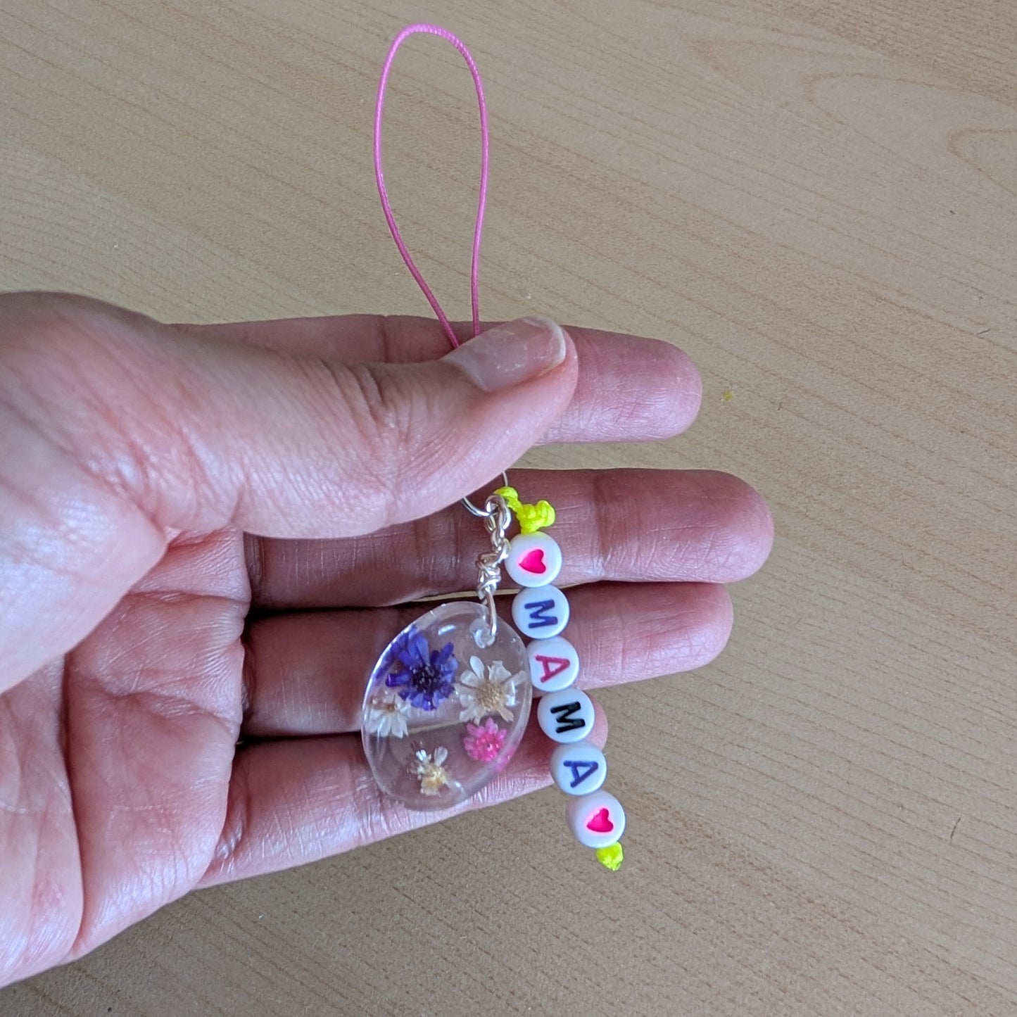 Spice up your phone with this charming resin charm, adorned with real dried flowers and beads. The 3.75 inch length adds a touch of flair to any device. (It's like a bouquet, but for your phone!)

Phone charm - Resin charm with dried flowers and beads