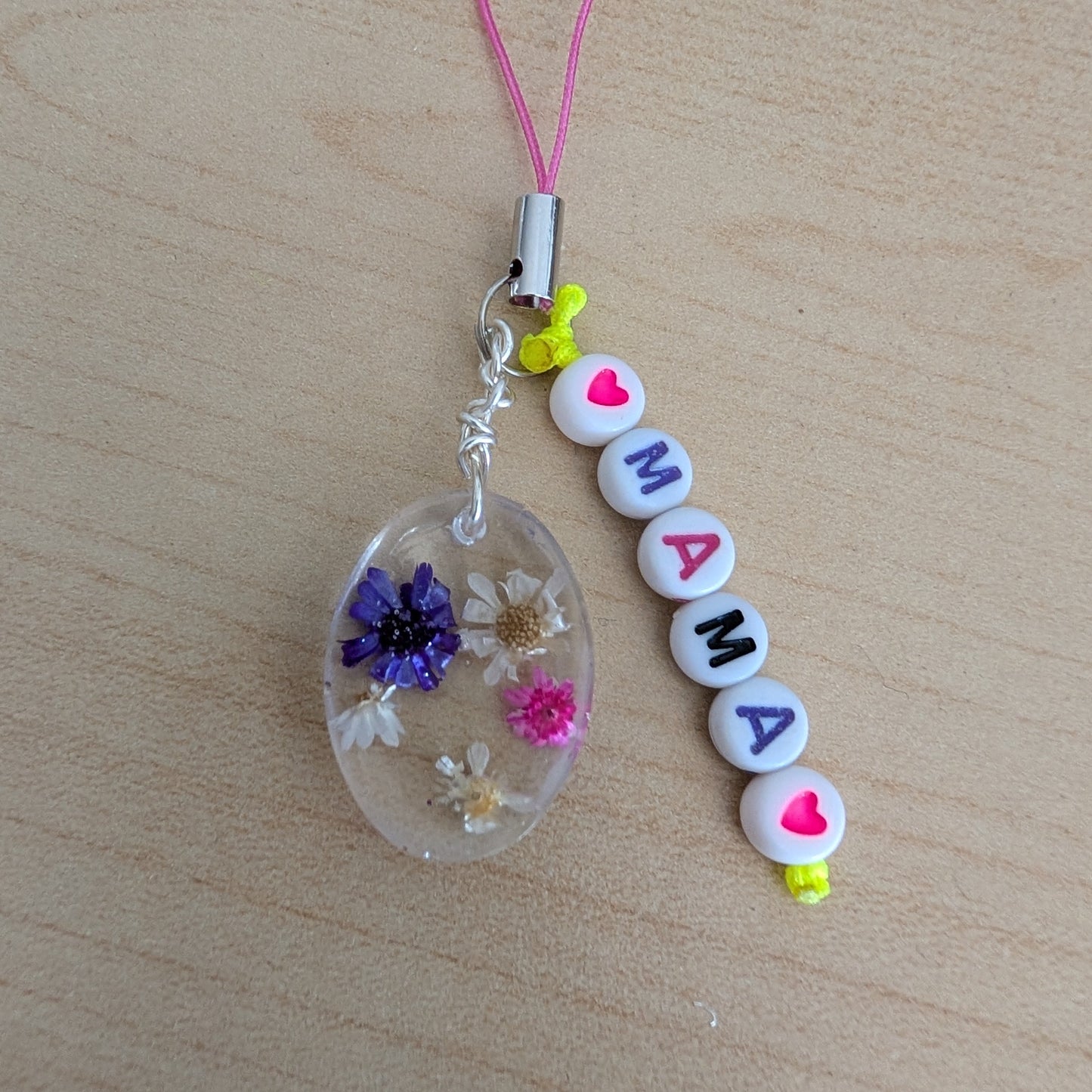Spice up your phone with this charming resin charm, adorned with real dried flowers and beads. The 3.75 inch length adds a touch of flair to any device. (It's like a bouquet, but for your phone!)

Phone charm - Resin charm with dried flowers and beads