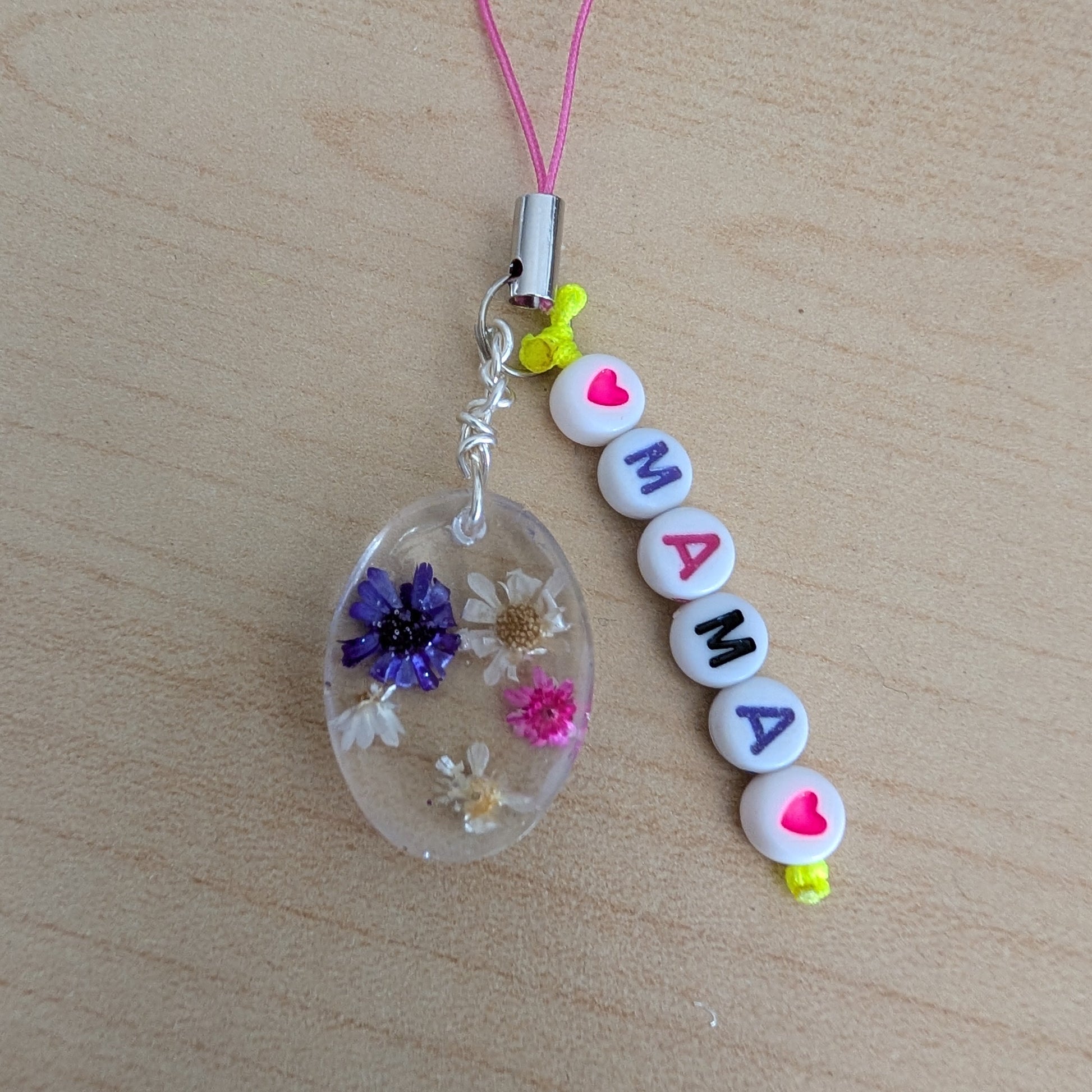 Spice up your phone with this charming resin charm, adorned with real dried flowers and beads. The 3.75 inch length adds a touch of flair to any device. (It's like a bouquet, but for your phone!)

Phone charm - Resin charm with dried flowers and beads