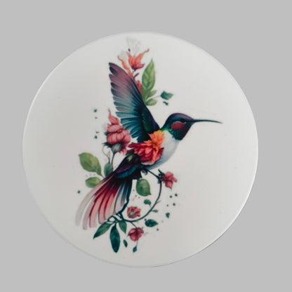 Enhance your home decor with our round ceramic coaster featuring a beautiful hummingbird design. Made with durable materials, this coaster provides protection for your furniture while adding a touch of nature to your space. Expertly crafted for long-lasting use, it's the perfect addition to any household.