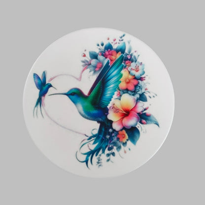Enhance your home decor with our round ceramic coaster featuring a beautiful hummingbird design. Made with durable materials, this coaster provides protection for your furniture while adding a touch of nature to your space. Expertly crafted for long-lasting use, it's the perfect addition to any household.