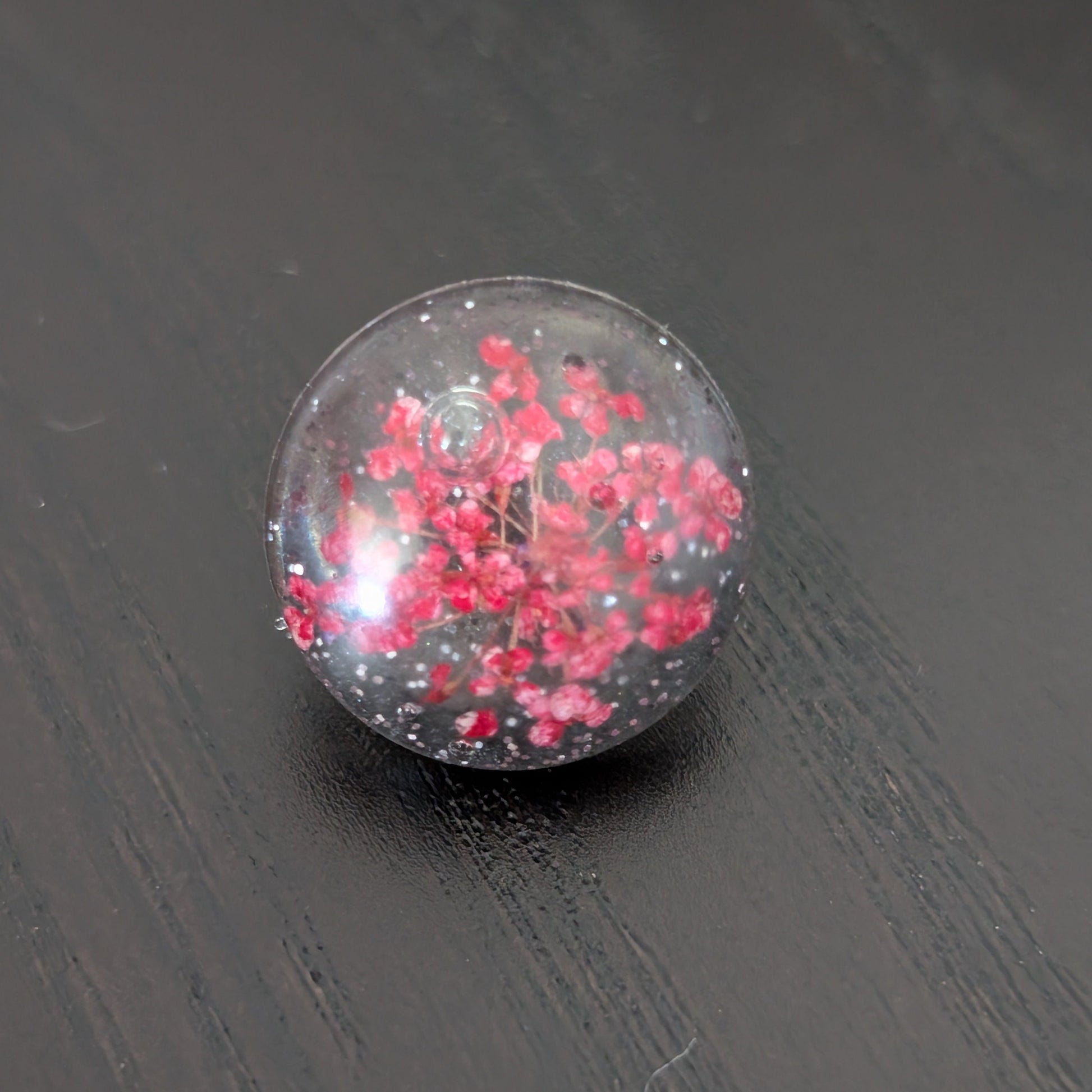 Add a touch of nature to your outfit with our Pin - 3D dried flower resin pin. The intricate design and 3D effect will surely catch everyone's eye. With the sturdy silver butterfly clutch, your pin will stay securely in place. Elevate your style with this unique and beautiful accessory.