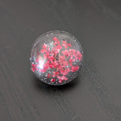 Add a touch of nature to your outfit with our Pin - 3D dried flower resin pin. The intricate design and 3D effect will surely catch everyone's eye. With the sturdy silver butterfly clutch, your pin will stay securely in place. Elevate your style with this unique and beautiful accessory.