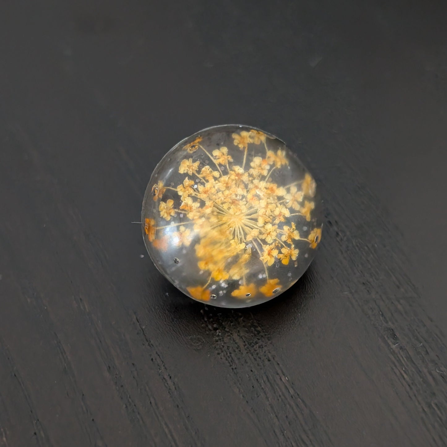 Add a touch of nature to your outfit with our Pin - 3D dried flower resin pin. The intricate design and 3D effect will surely catch everyone's eye. With the sturdy silver butterfly clutch, your pin will stay securely in place. Elevate your style with this unique and beautiful accessory.