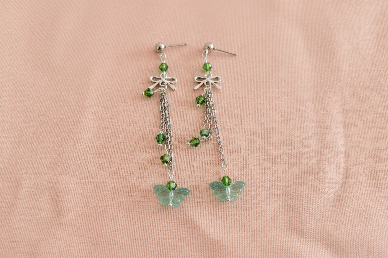 Elevate your everyday style with these enchanting butterfly earrings, featuring delicate silver chains, a charming bow accent, and sparkling crystal beads suspended from classic silver ball post studs. At approximately 3 inches in length, they offer the perfect balance of presence and wearability, making them ideal for both casual outings and special occasions. Weighing just 0.18 oz, these lightweight beauties won't weigh you down, allowing you to wear them comfortably all day long. The intricate design com