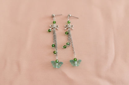 Elevate your everyday style with these enchanting butterfly earrings, featuring delicate silver chains, a charming bow accent, and sparkling crystal beads suspended from classic silver ball post studs. At approximately 3 inches in length, they offer the perfect balance of presence and wearability, making them ideal for both casual outings and special occasions. Weighing just 0.18 oz, these lightweight beauties won't weigh you down, allowing you to wear them comfortably all day long. The intricate design com