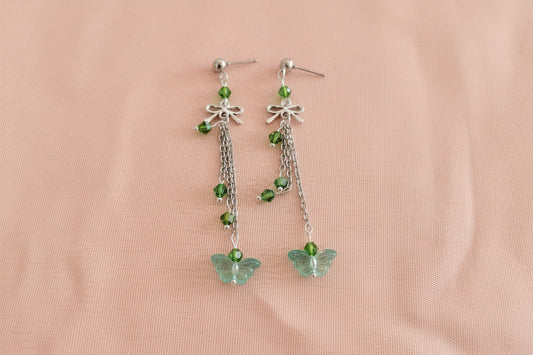 Elevate your everyday style with these enchanting butterfly earrings, featuring delicate silver chains, a charming bow accent, and sparkling crystal beads suspended from classic silver ball post studs. At approximately 3 inches in length, they offer the perfect balance of presence and wearability, making them ideal for both casual outings and special occasions. Weighing just 0.18 oz, these lightweight beauties won't weigh you down, allowing you to wear them comfortably all day long. The intricate design com