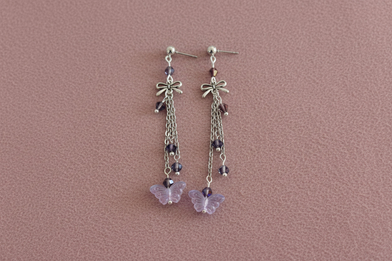 Elevate your everyday style with these enchanting butterfly earrings, featuring delicate silver chains, a charming bow accent, and sparkling crystal beads suspended from classic silver ball post studs. At approximately 3 inches in length, they offer the perfect balance of presence and wearability, making them ideal for both casual outings and special occasions. Weighing just 0.18 oz, these lightweight beauties won't weigh you down, allowing you to wear them comfortably all day long. The intricate design com