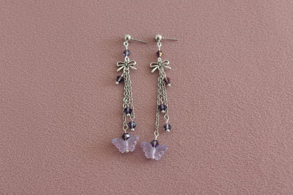 Elevate your everyday style with these enchanting butterfly earrings, featuring delicate silver chains, a charming bow accent, and sparkling crystal beads suspended from classic silver ball post studs. At approximately 3 inches in length, they offer the perfect balance of presence and wearability, making them ideal for both casual outings and special occasions. Weighing just 0.18 oz, these lightweight beauties won't weigh you down, allowing you to wear them comfortably all day long. The intricate design com