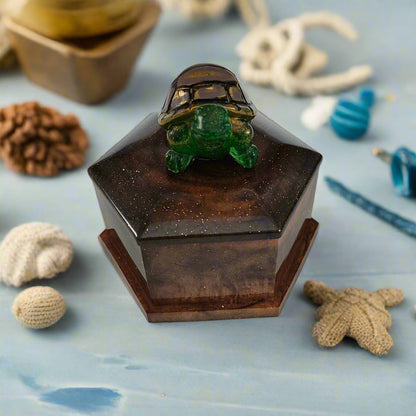 Add a playful touch to your home decor with this Knickknack! The resin hexagon trinket box features a turtle lid and is the perfect size for storing small treasures. With dimensions of 2.5 x 3 x 1 inches and weighing only 3.4 ounces, it's a quirky and lightweight addition to any room.
