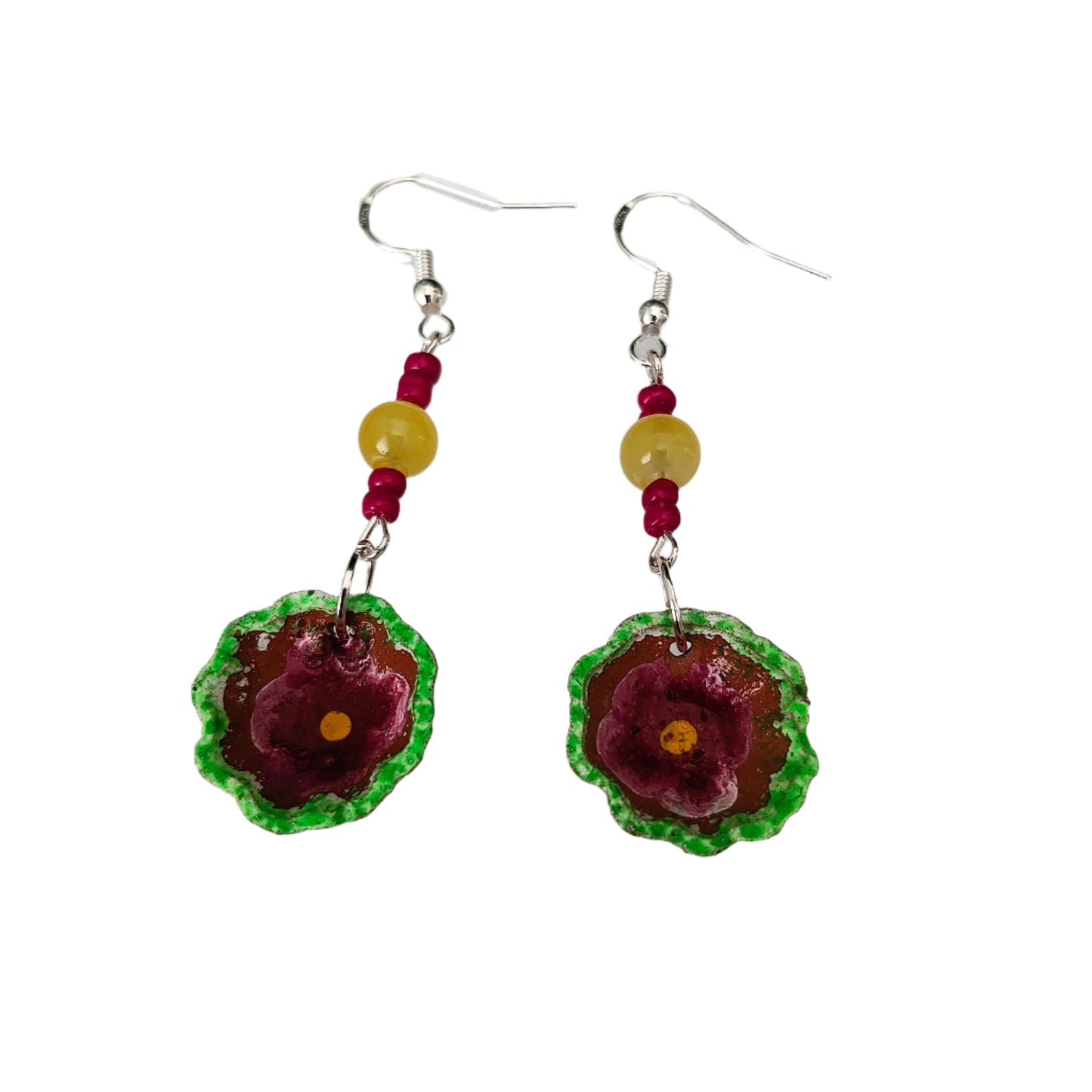 Add a pop of playful charm to your outfit with these Small Mexican plate earrings. Featuring delicate ceramic plates adorned with crystal and seed beads, these silver hook earrings measure 2.5 inches in length and weigh just 0.09 oz. Perfect for adding a touch of quirkiness to any look!