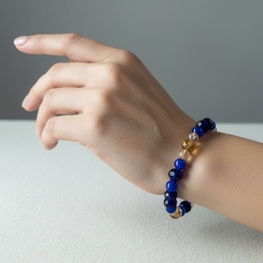 Add a touch of elegance to any outfit with our Bracelet - Elastic 6mm & 8 mm blue & gold glass beads. The elastic design ensures a comfortable fit for all wrist sizes. At a weight of just 0.38 oz, it is lightweight and easy to wear all day long. Elevate your style with this stunning bracelet.

Bracelet - Elastic 6mm & 8 mm blue & gold glass beads