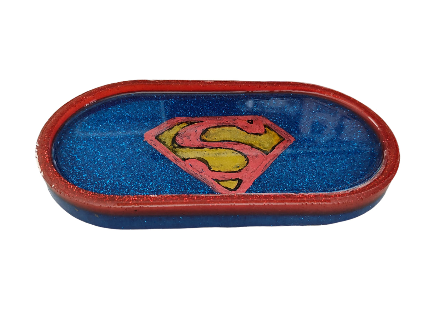 This Knickknack trinket dish not only adds a fun touch to any space with its super hero theme, but also serves as a functional and stylish storage option for small items. Made of durable resin, it is designed to keep jewelry, change, and other trinkets organized and easily accessible.