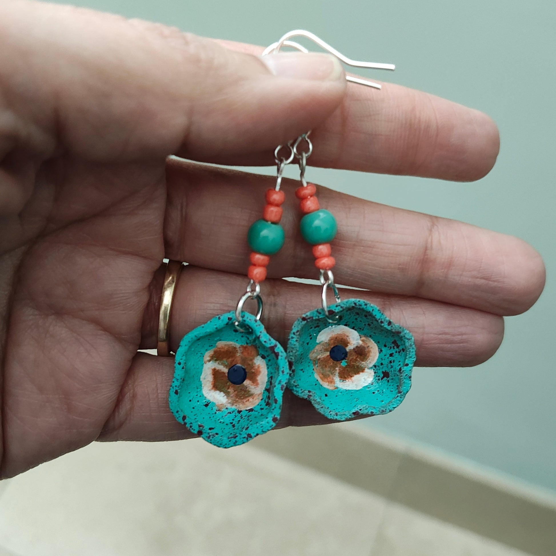 Add a taste of Mexico to your wardrobe with our Earrings! Unique ceramic plates adorned with crystal and seed beads dangle from sleek silver hooks. At 2.5 inches long and weighing only 0.13 oz, these earrings are a lightweight and stylish addition to any outfit.