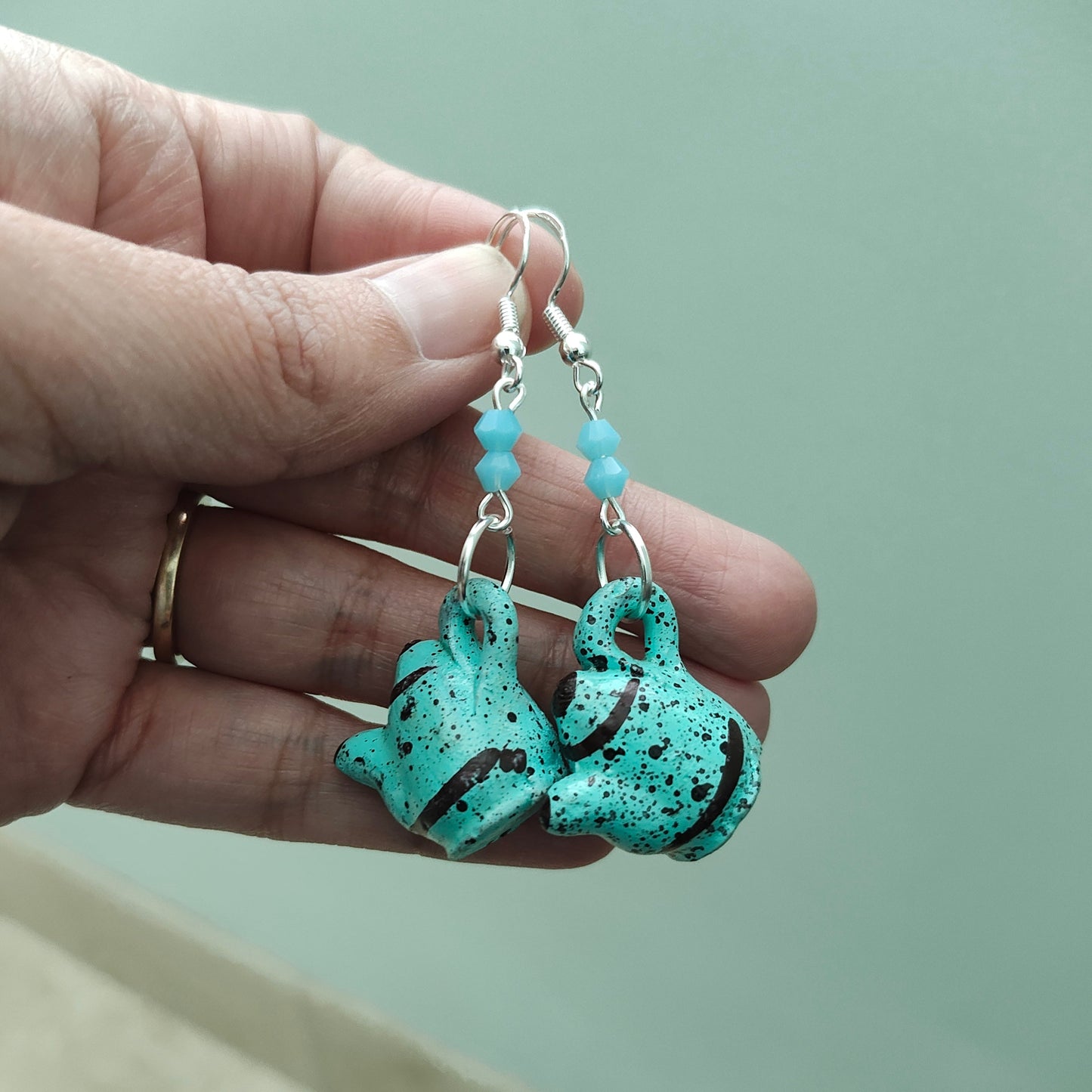 Add a playful and quirky touch to your jewelry collection with our Ceramic Kettle Earrings! These unique earrings feature colorful beads on a silver hook, adding a touch of whimsy to any outfit. Measuring at 2.25 inches in length and weighing just 0.19 ounces, they're the perfect statement piece for any occasion.