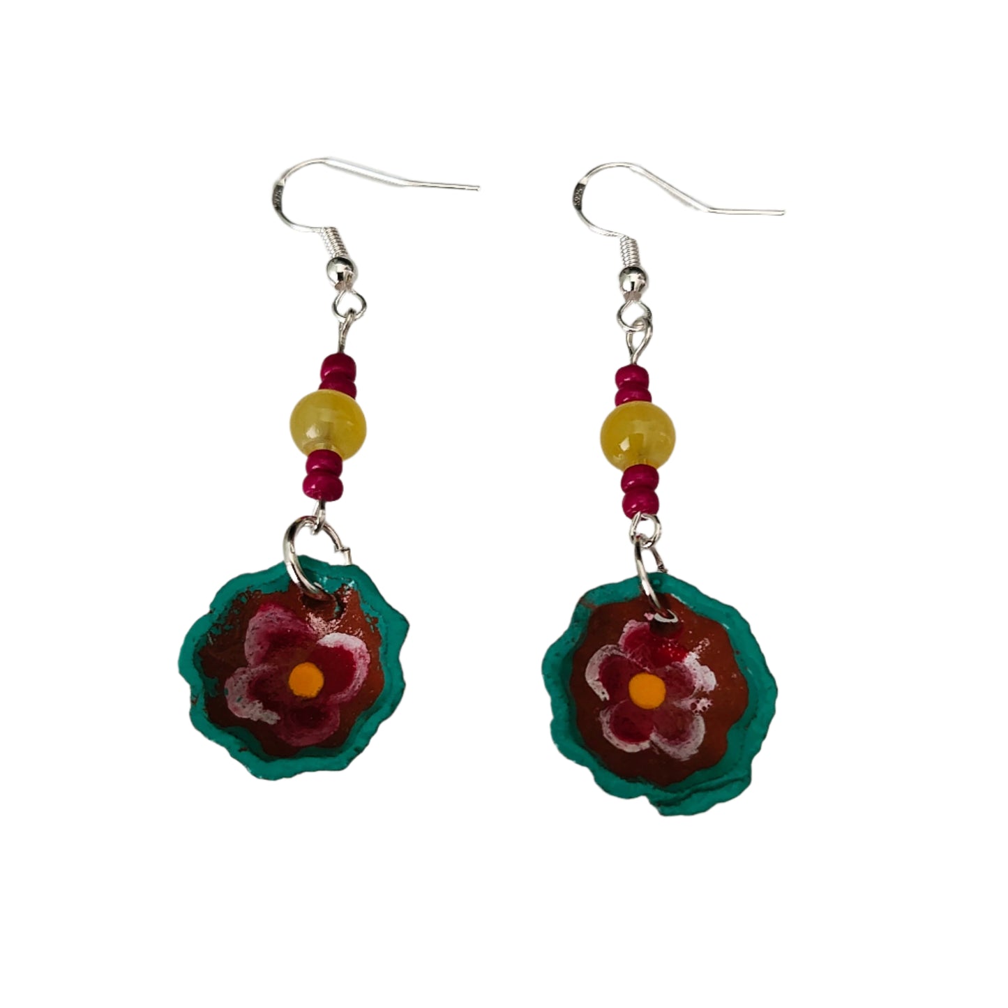 Add a pop of playful charm to your outfit with these Small Mexican plate earrings. Featuring delicate ceramic plates adorned with crystal and seed beads, these silver hook earrings measure 2.5 inches in length and weigh just 0.09 oz. Perfect for adding a touch of quirkiness to any look!