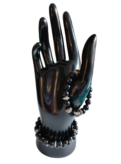 Experience the power of natural gemstones with our Black Stripe Agate Bracelet. The 6mm beads are expertly crafted for a comfortable elastic fit. The striking black stripes are complemented by silver spacer beads, adding a touch of elegance to this unique accessory. Feel confident and stylish with every wear!