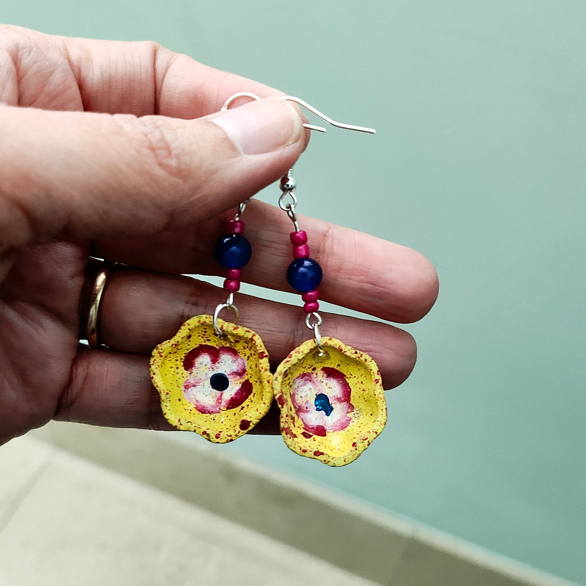 Add a taste of Mexico to your wardrobe with our Earrings! Unique ceramic plates adorned with crystal and seed beads dangle from sleek silver hooks. At 2.5 inches long and weighing only 0.13 oz, these earrings are a lightweight and stylish addition to any outfit.