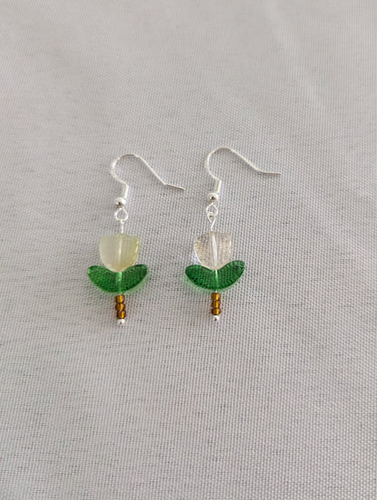 Delicate crystal and seed beads form an enchanting flower design, suspended from hypoallergenic 925 sterling silver hooks. These lightweight earrings measure just 1.5 inches, making them perfect for everyday elegance or layering with other pieces. At only 0.1 oz, they're comfortable enough to wear all day without fatigue. The shimmering bead work catches light beautifully, adding a touch of sparkle and sophistication to any outfit. Ideal for those who appreciate handcrafted jewelry with timeless appeal.