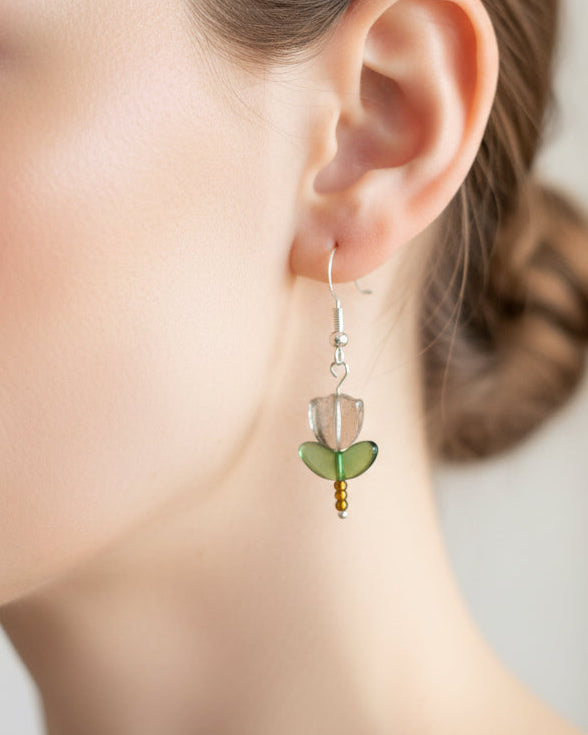 Delicate crystal and seed beads form an enchanting flower design, suspended from hypoallergenic 925 sterling silver hooks. These lightweight earrings measure just 1.5 inches, making them perfect for everyday elegance or layering with other pieces. At only 0.1 oz, they're comfortable enough to wear all day without fatigue. The shimmering bead work catches light beautifully, adding a touch of sparkle and sophistication to any outfit. Ideal for those who appreciate handcrafted jewelry with timeless appeal.