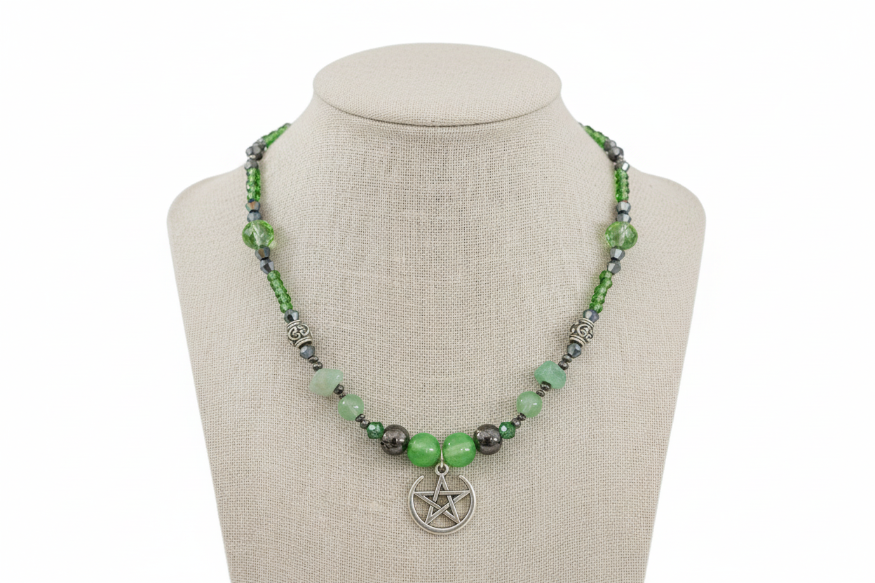 Necklace with green and black beads on a mannequin bust against a white background