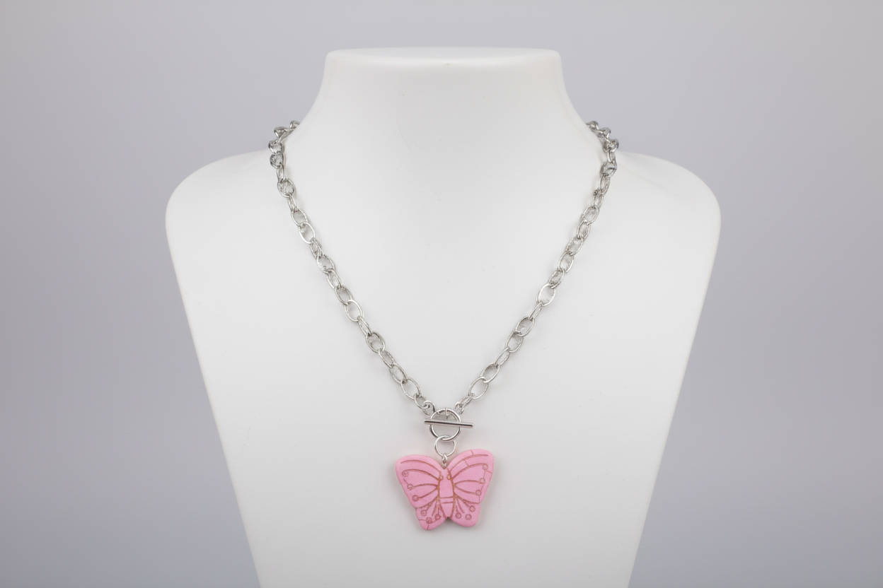 Necklace with a pink butterfly pendant on a mannequin bust against a gray background