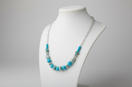 A stainless steel round cable chain necklace with blue and silver acrylic beads, featuring a lightweight design with a 2-inch extension.
