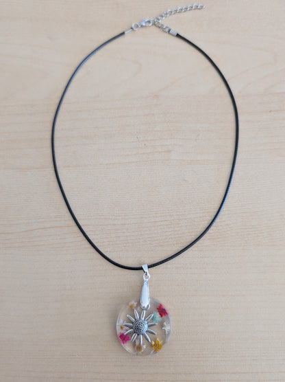 Necklace - 17.5 inches resin circle with flowers and silver flower charm on black leather cord with clasp