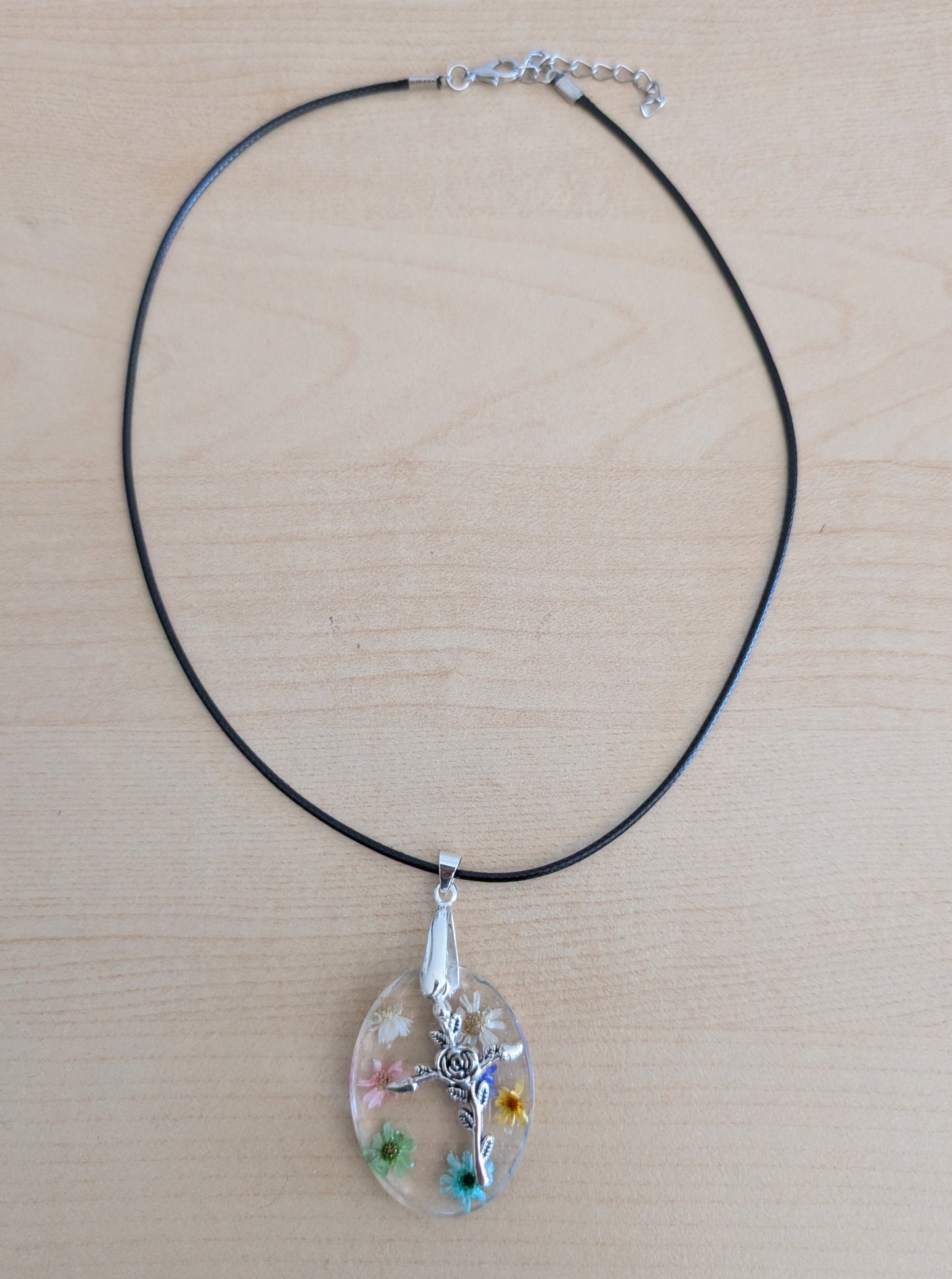 Necklace - 17.5 inches resin oval with flowers and silver cross charm on black leather cord with clasp