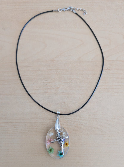 Necklace - 17.5 inches resin oval with flowers and silver cross charm on black leather cord with clasp