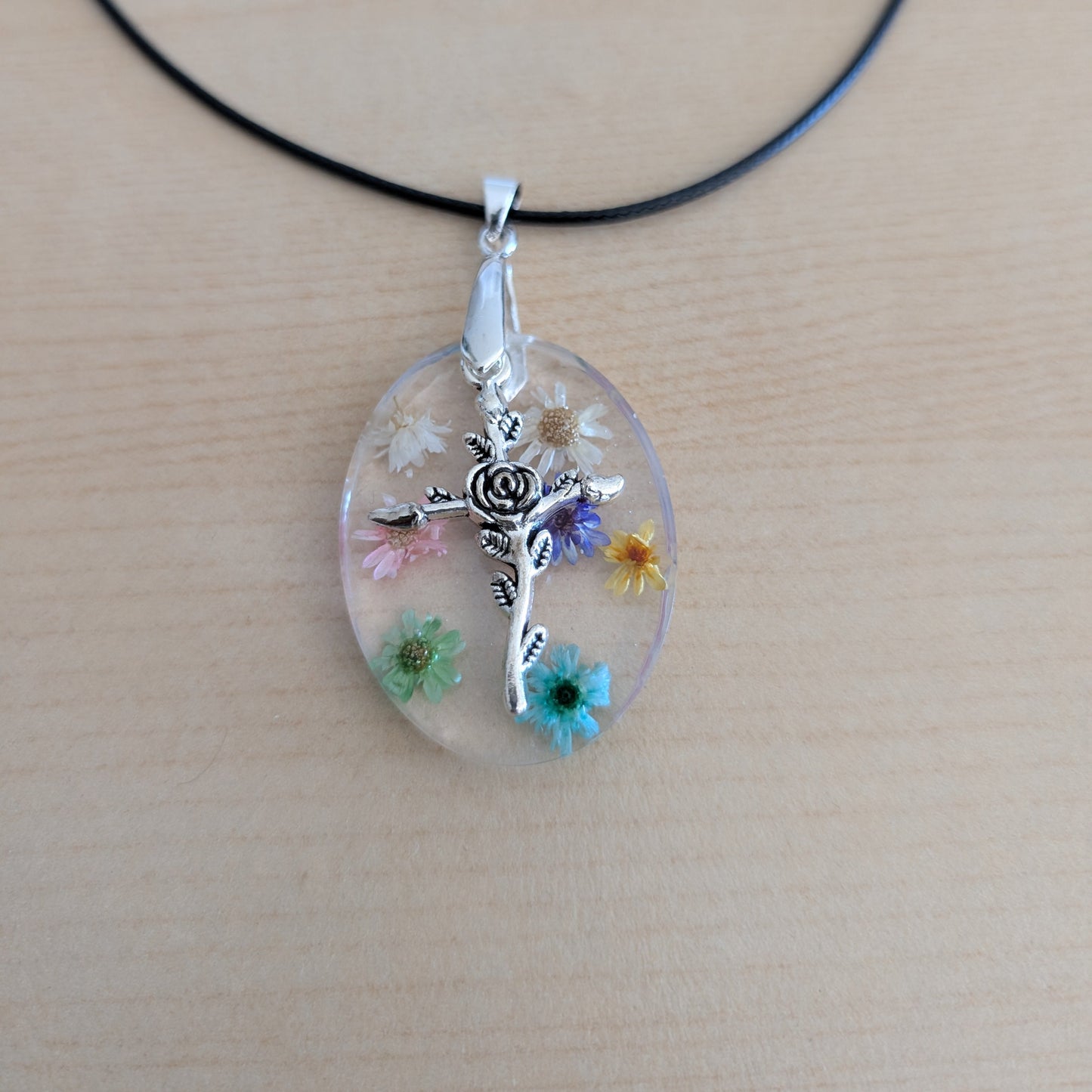 Necklace - 17.5 inches resin oval with flowers and silver cross charm on black leather cord with clasp