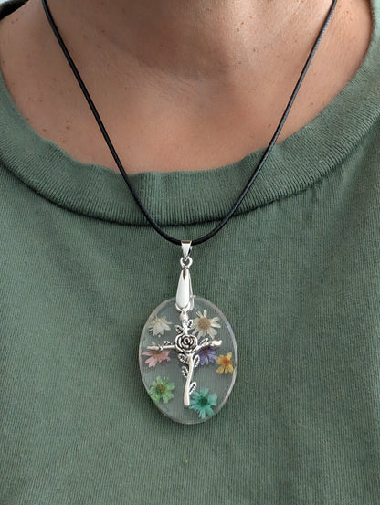 Necklace - 17.5 inches resin oval with flowers and silver cross charm on black leather cord with clasp